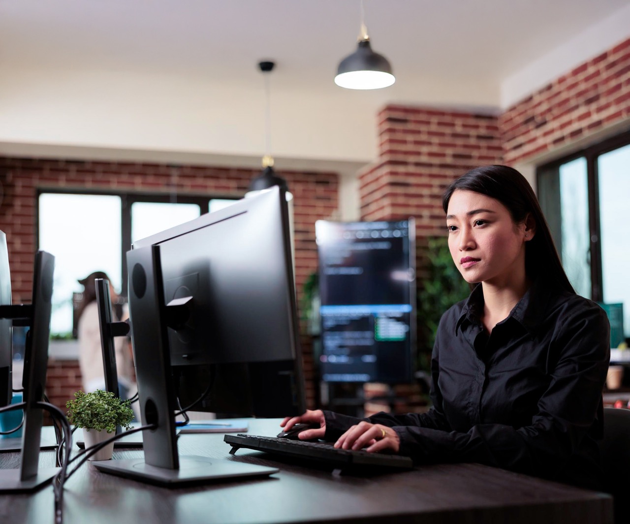 Asian woman in front working with monitor digitalisation